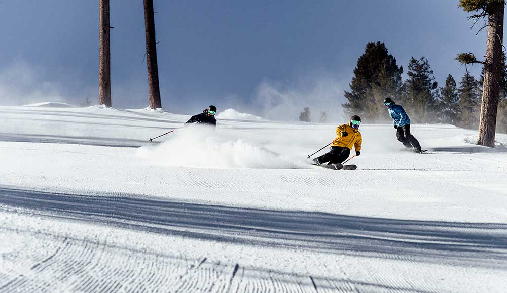 Three skiers enjoy a groomer at Sun Valley Idaho.