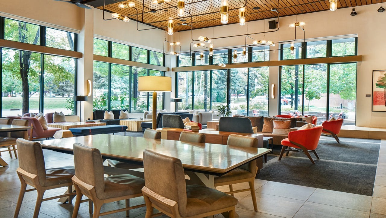 dining and seating area in the large with large windows overlooking downtown aspen