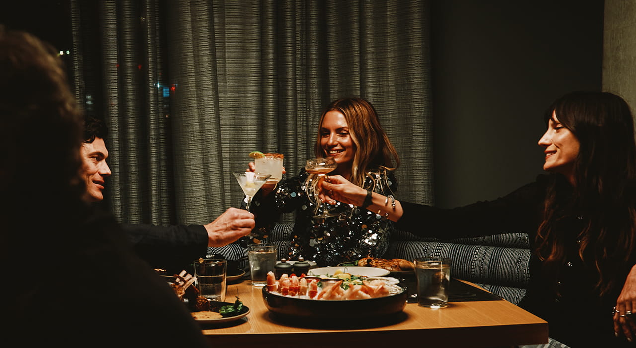 friends toasting at table in ajax