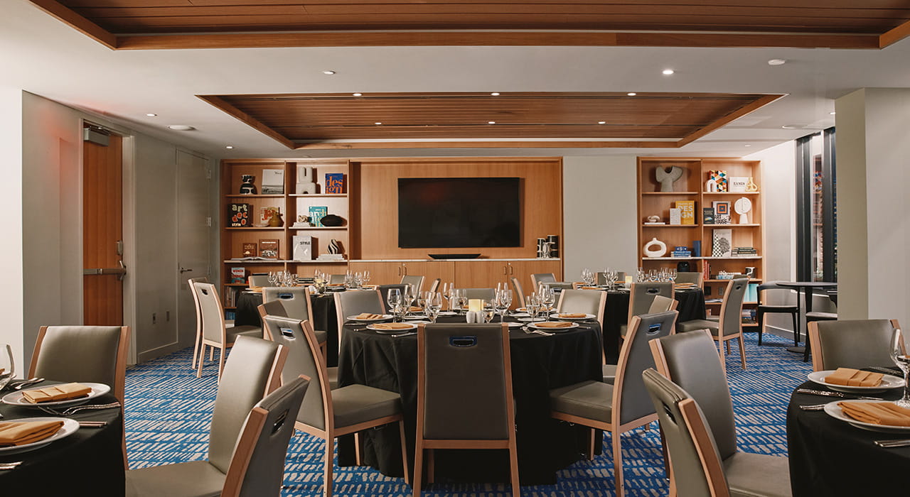 meeting space with table rounds and tv