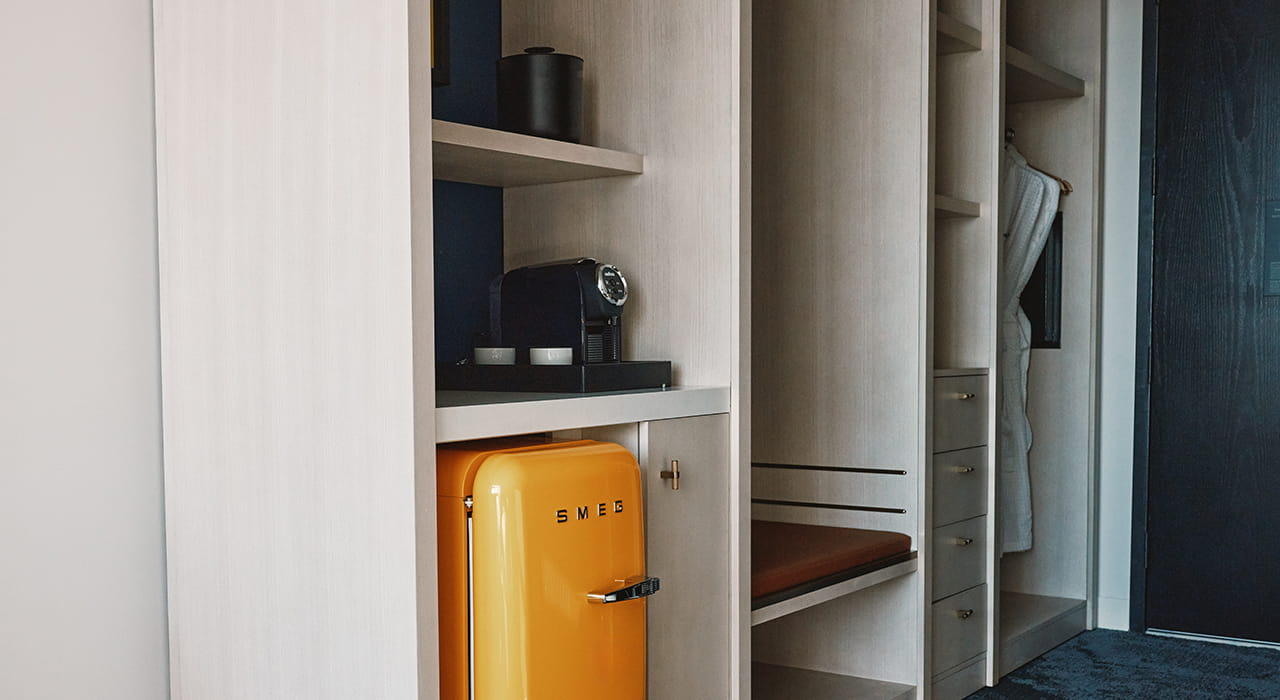 orange smeg fridge in guest room