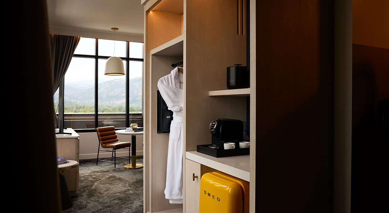 coffee maker, smeg fridge, and robe in storage area