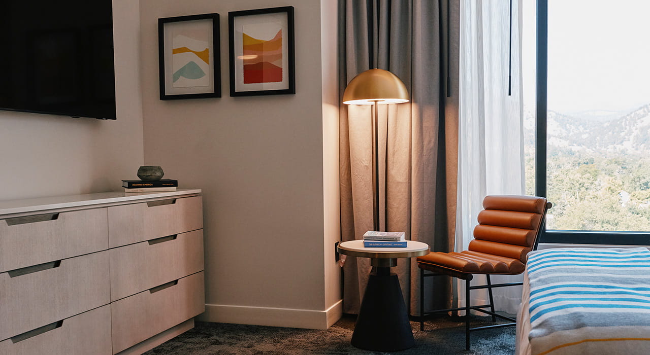 table, dresser and tv in guest room
