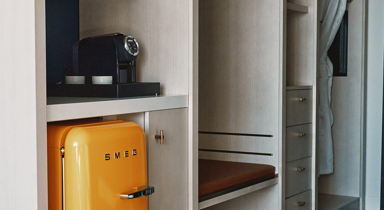 smeg fridge and coffee maker in guest room