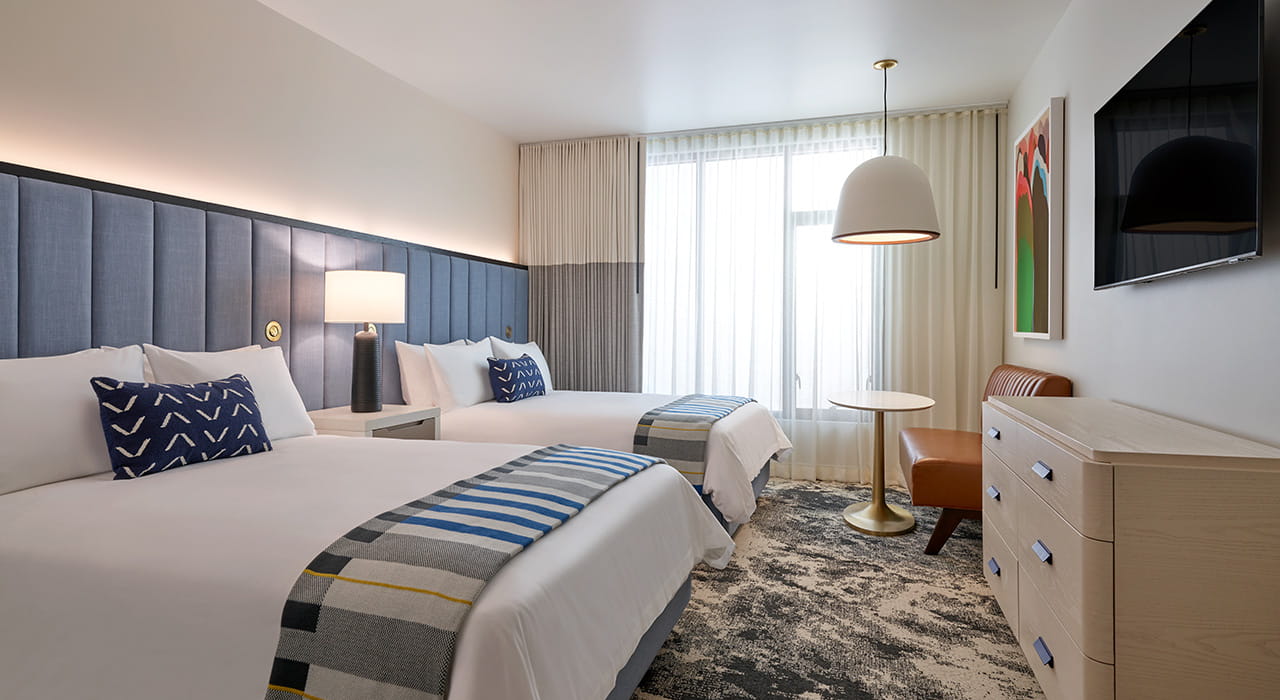 beds and table in queens guest room