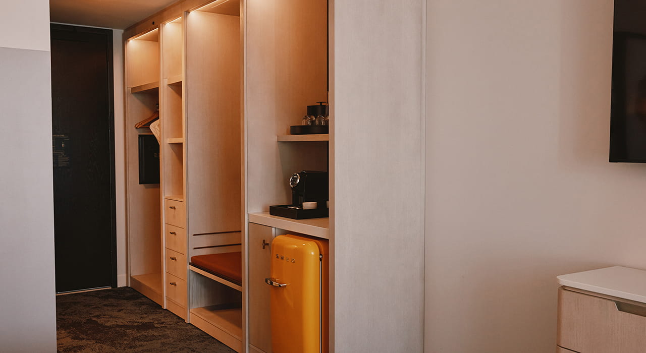 fridge and storage cubbies in room