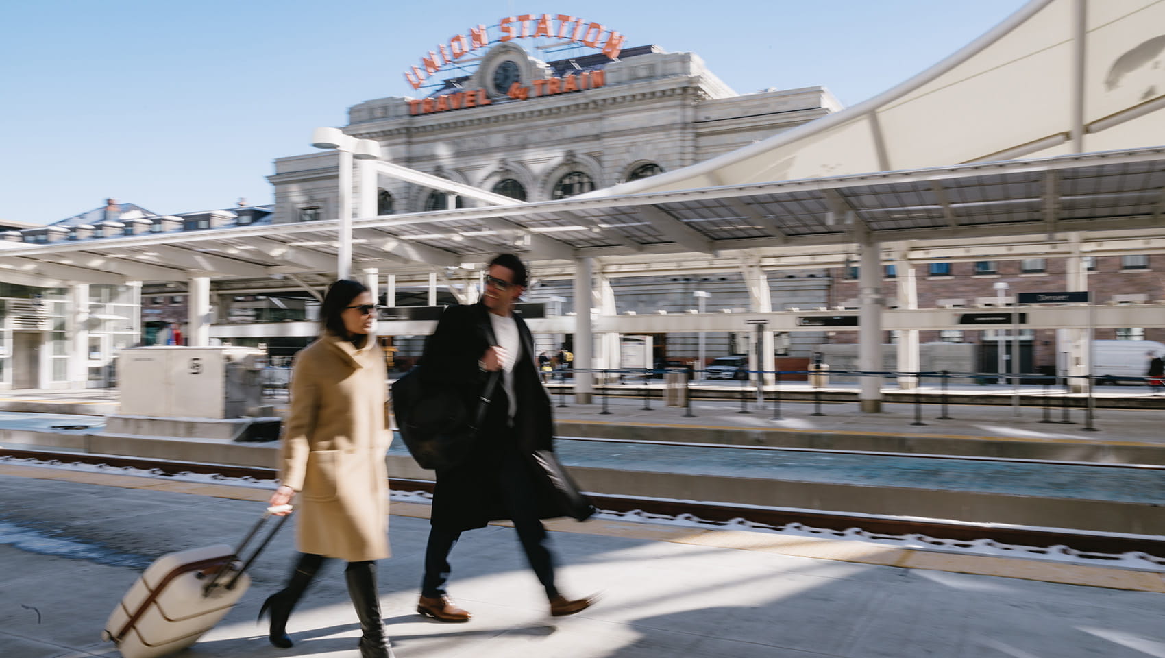 two business workers walking in front of union station