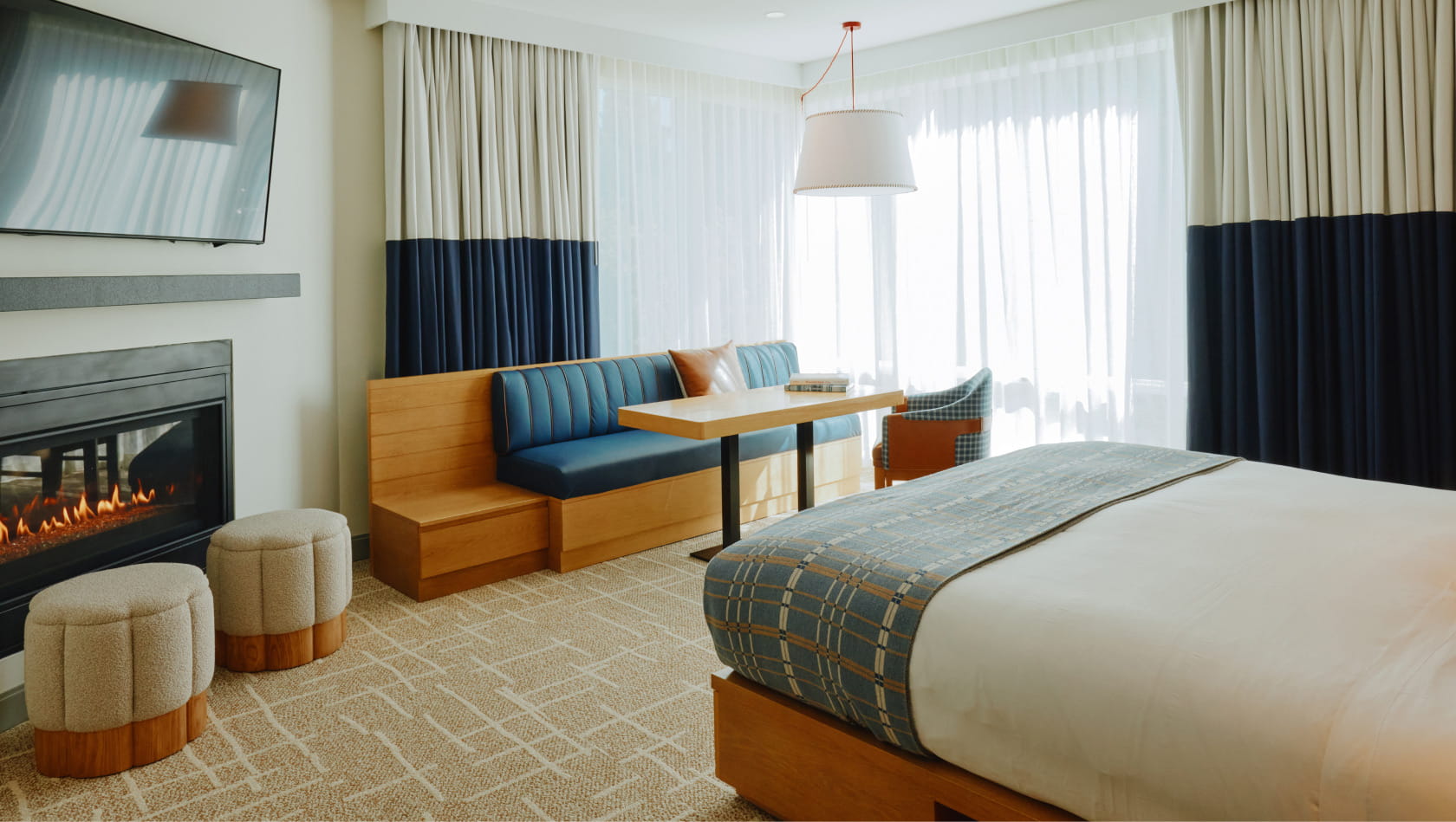 table, tv, and fireplace in guest room
