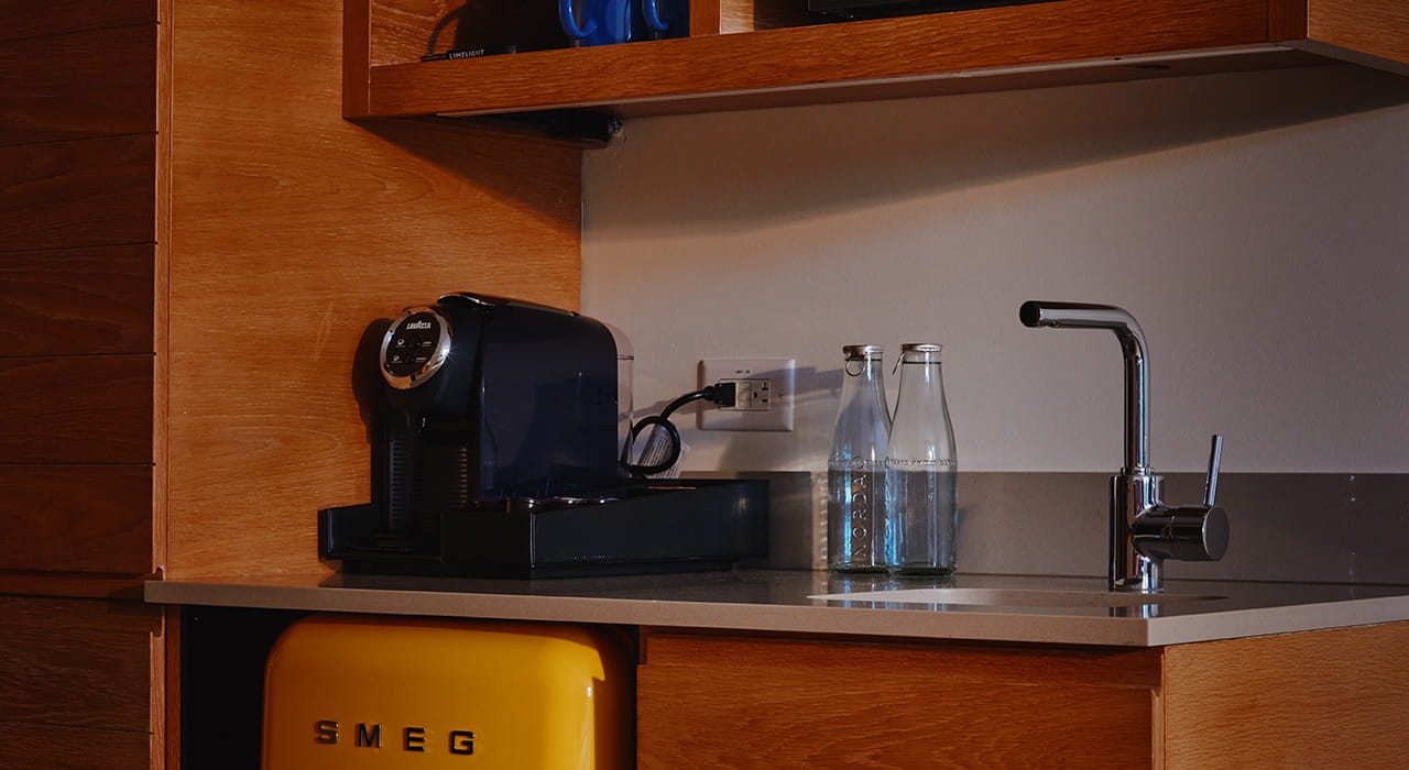 kitchenette in guest rooms with coffee maker, sink, smeg fridge