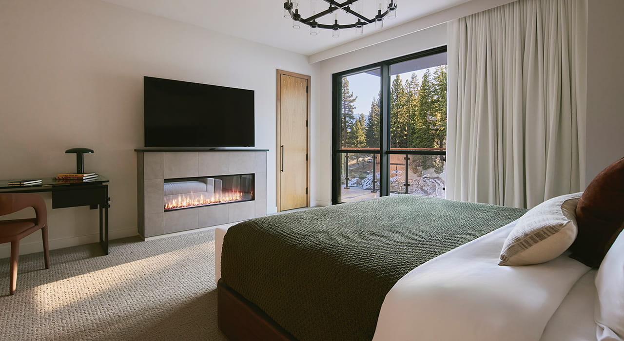 bedroom with balcony and fireplace in residence