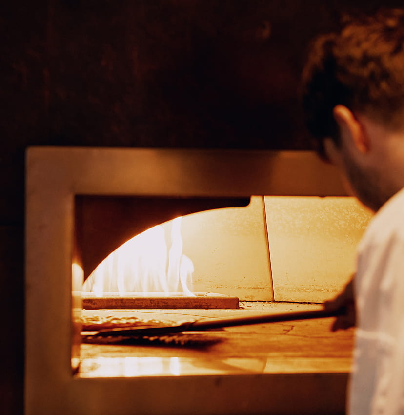 chef using pizza oven