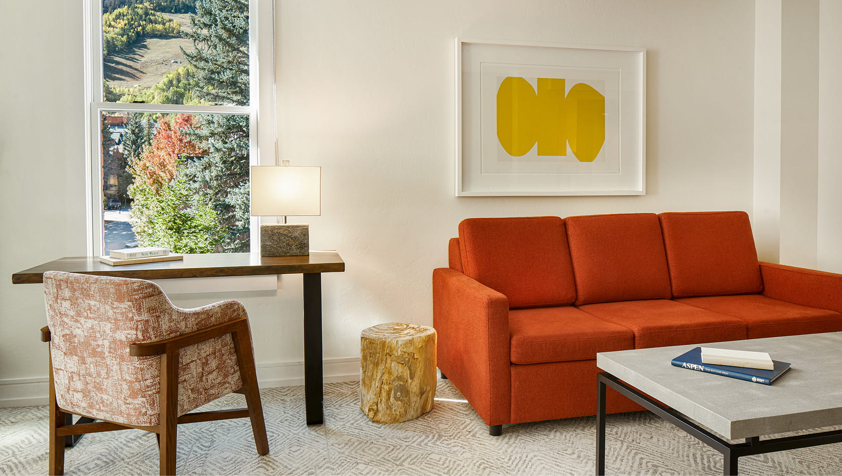 red couch and desk in guestroom