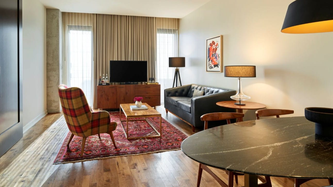 Hotel suite with a dining table and sitting area