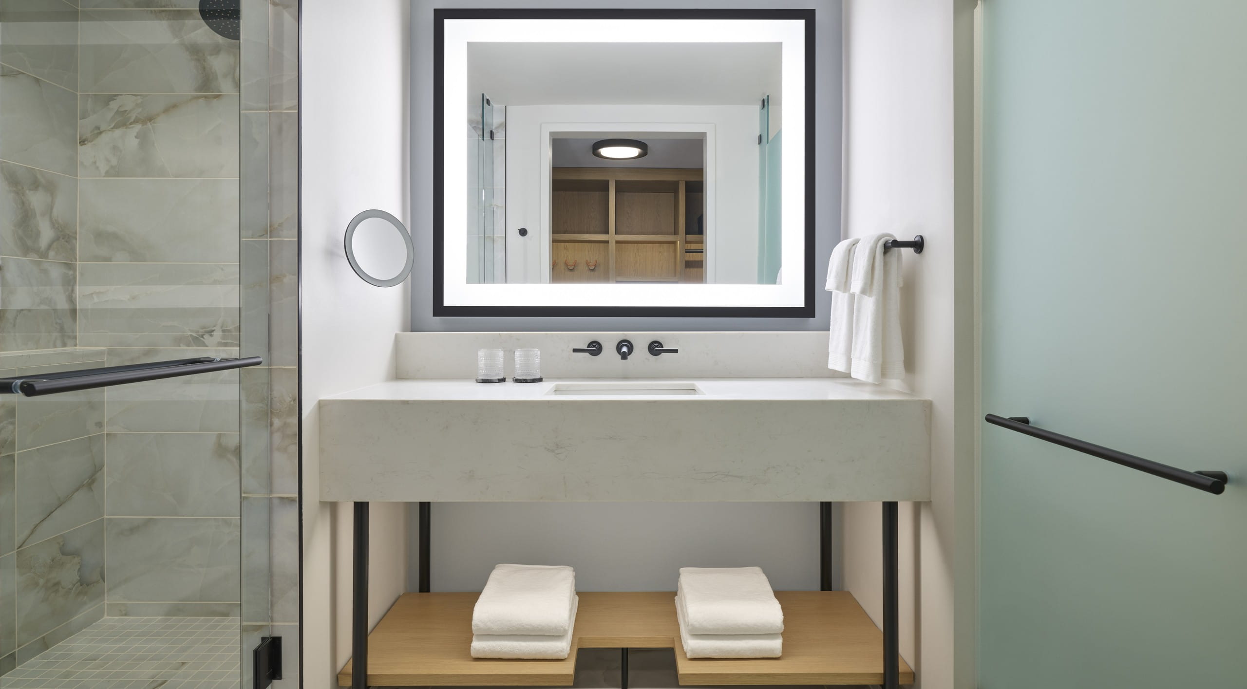 Hotel bathroom with lit up vanity sink