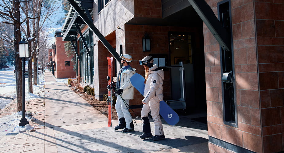 skiers walking out of limelight aspen front door