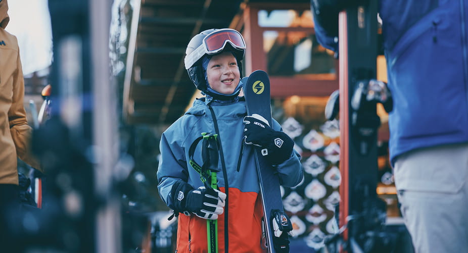 kid with skis outside