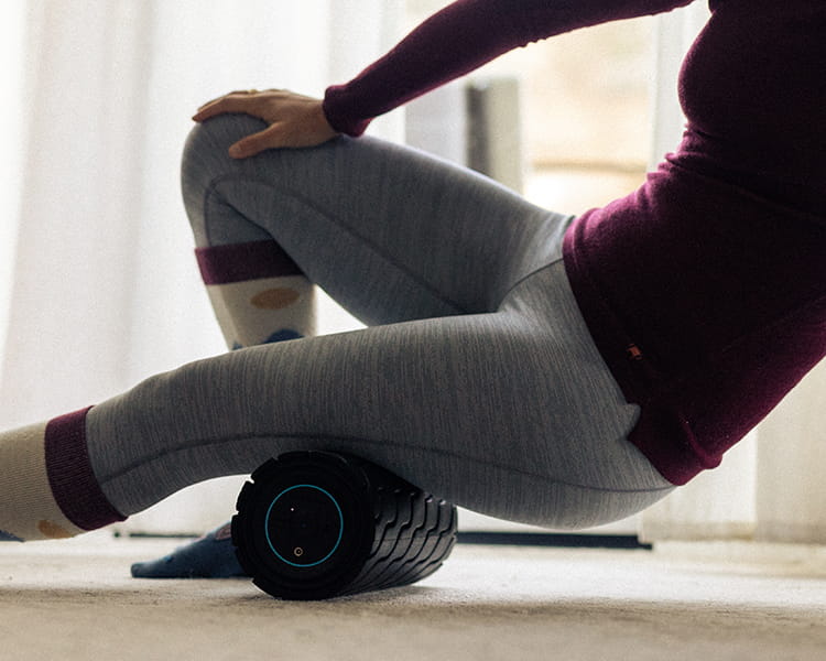 person using waveroller on leg