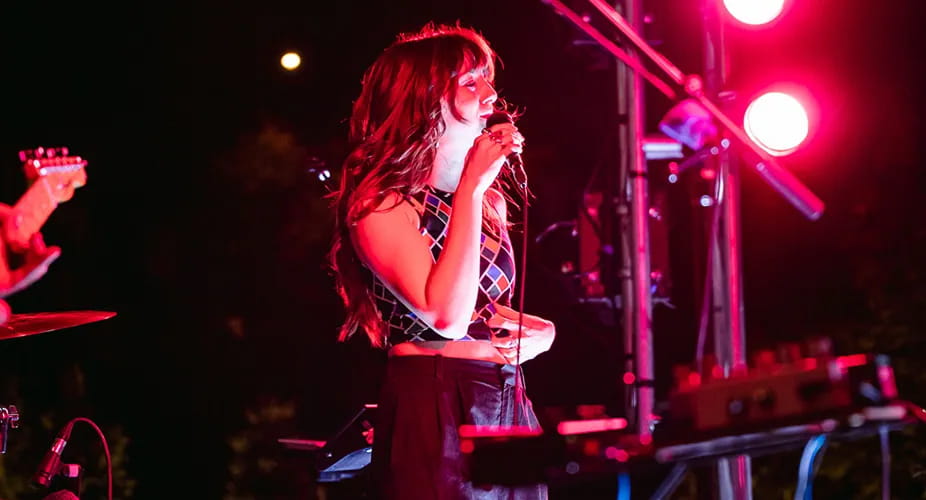 woman singing on stage