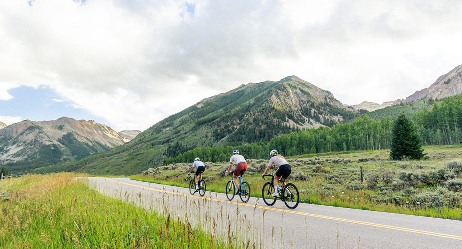 three bikers biking in the mountains
