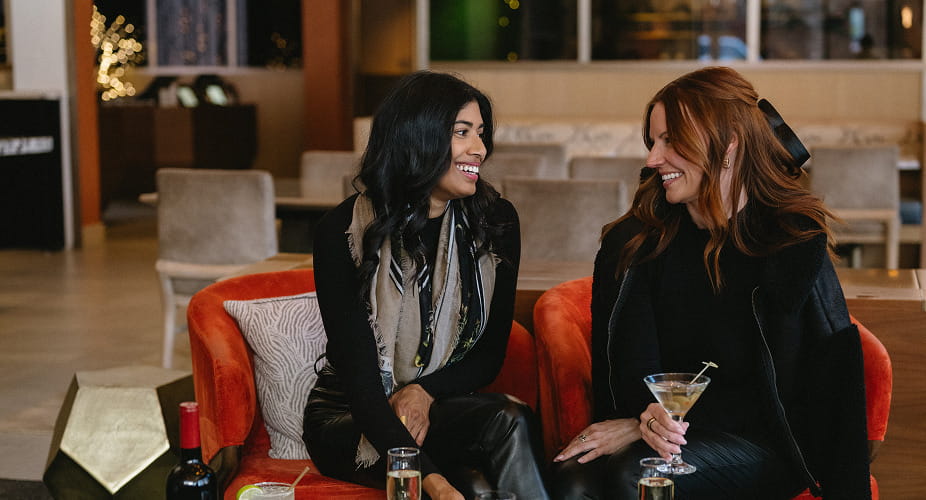 two women talking and drink at the lounge