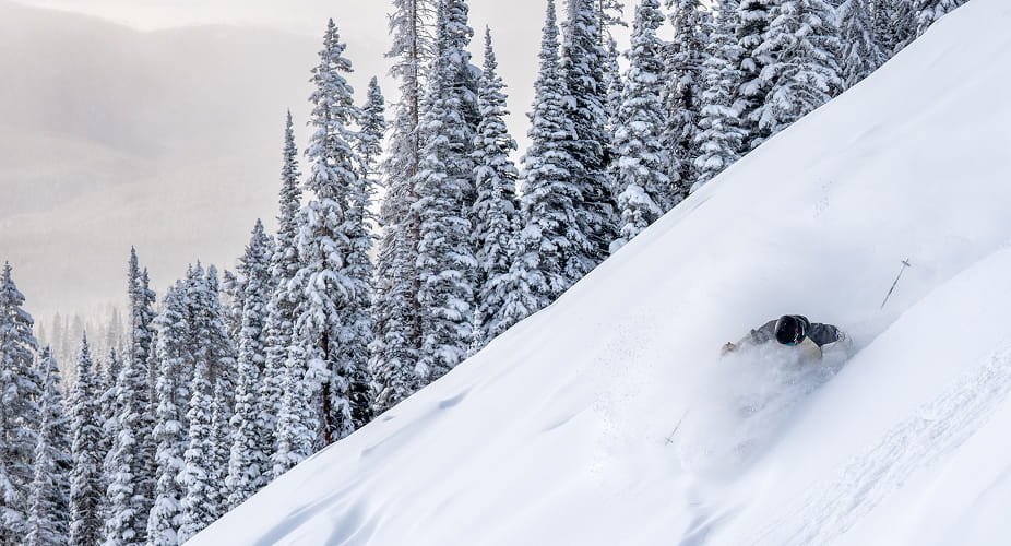skier skiing powder on aspen mountain
