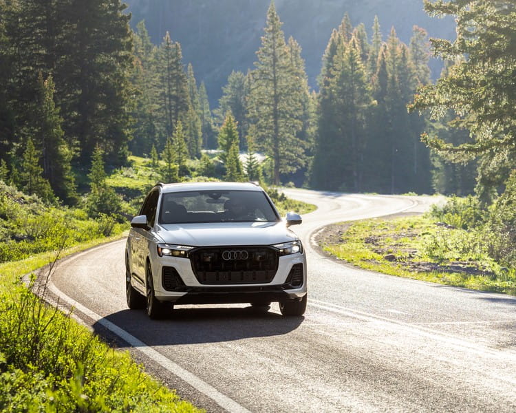White Audi SUV car on a mountain road in Colorado
