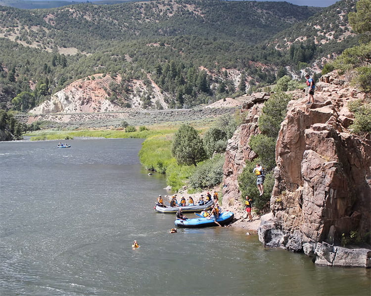 people rafting mountain river