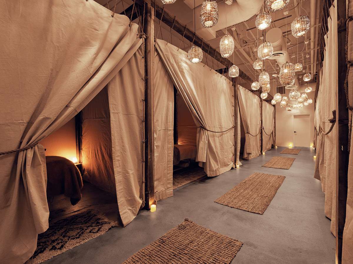 Spa beds with curtains and warm lighting