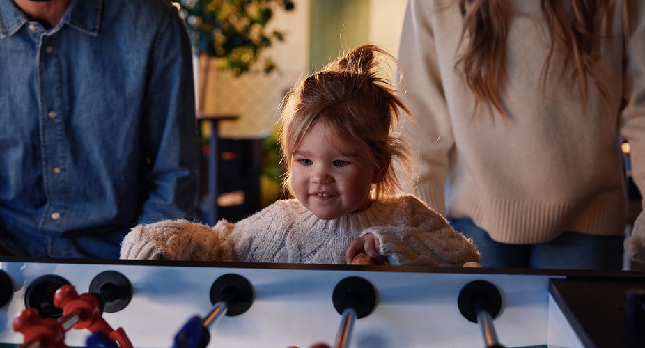 little girl playing foosball