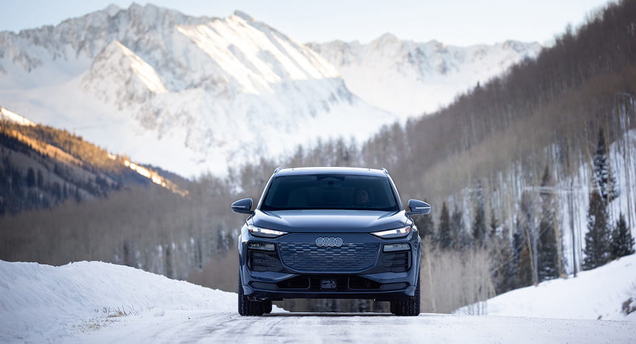 audi car driving on road in front of mountains
