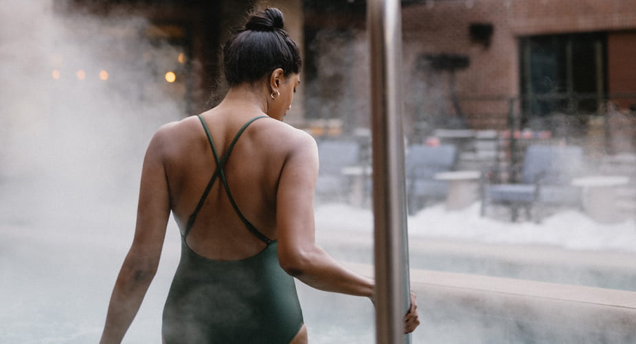 woman stepping into hotel hot tub