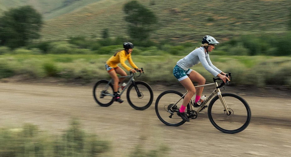 two women gravel biking