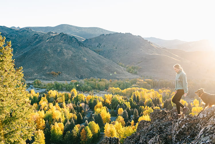 woman walking in mountains in the fall