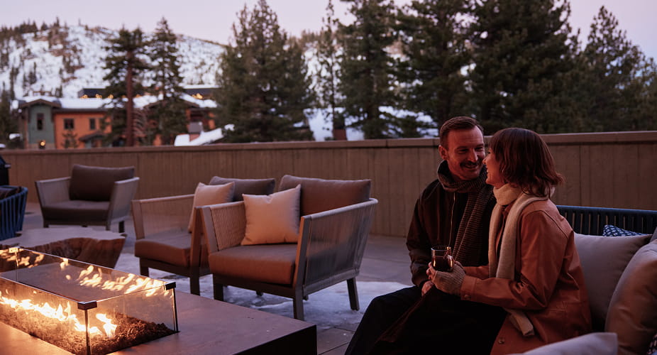 couple sitting by outdoor firepit