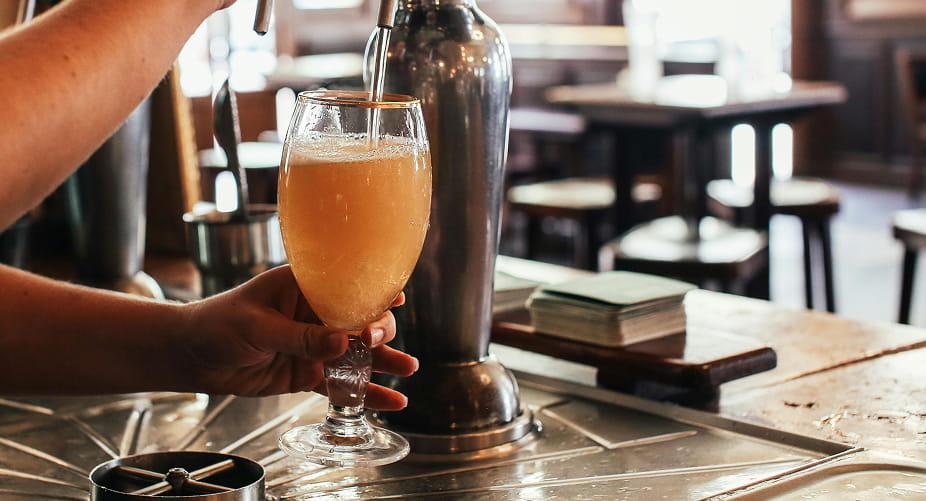 person pouring beer