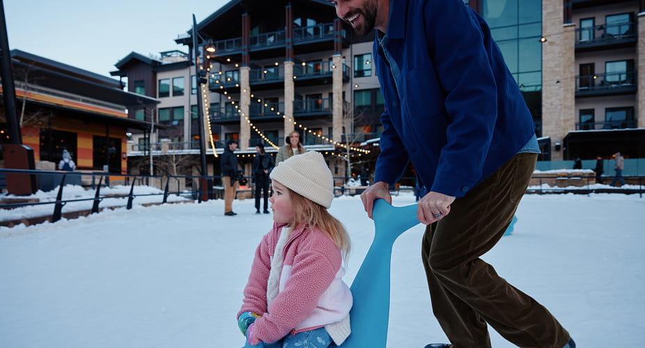 kid and parent on snowmass ice rink