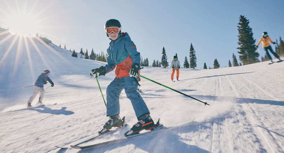 child skiing down mountain