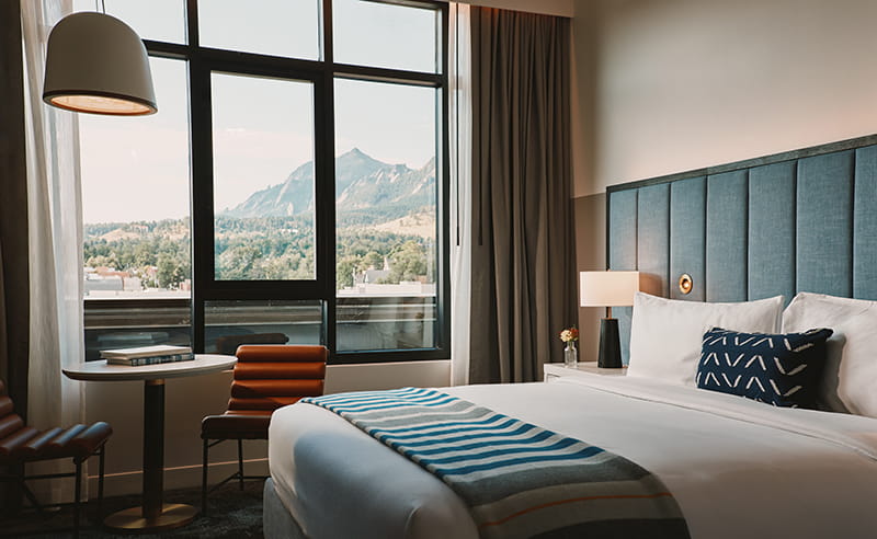 bed in guestroom overlooking flatirons