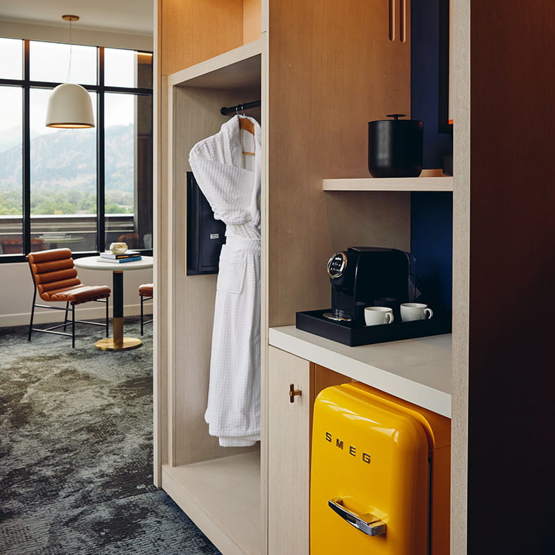 cubby storage area, smeg, and robe in guest room