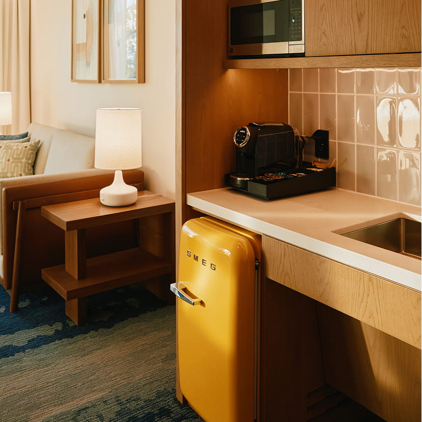 kitchenette in guest rooms with coffee maker, sink, smeg fridge