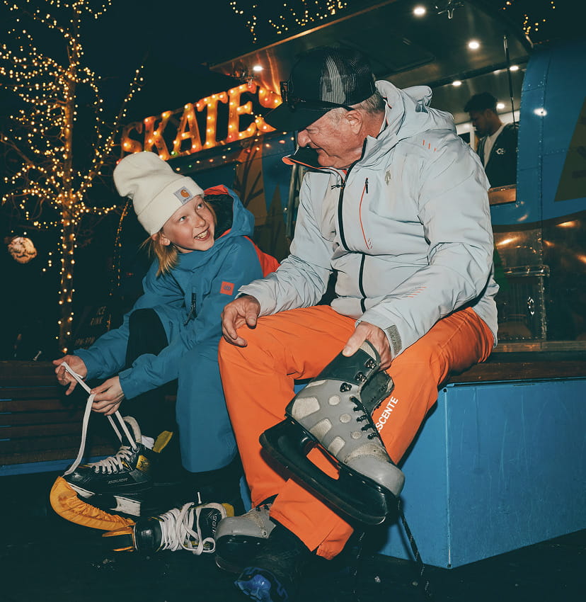 kid with dad putting on skates