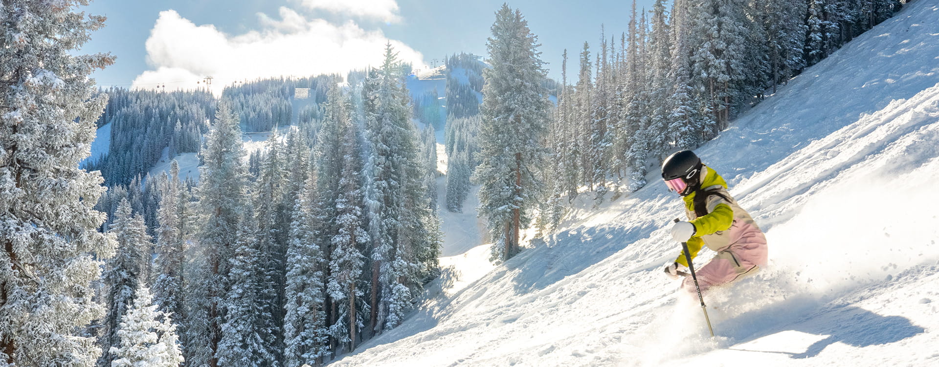skier skiing down aspen mountain