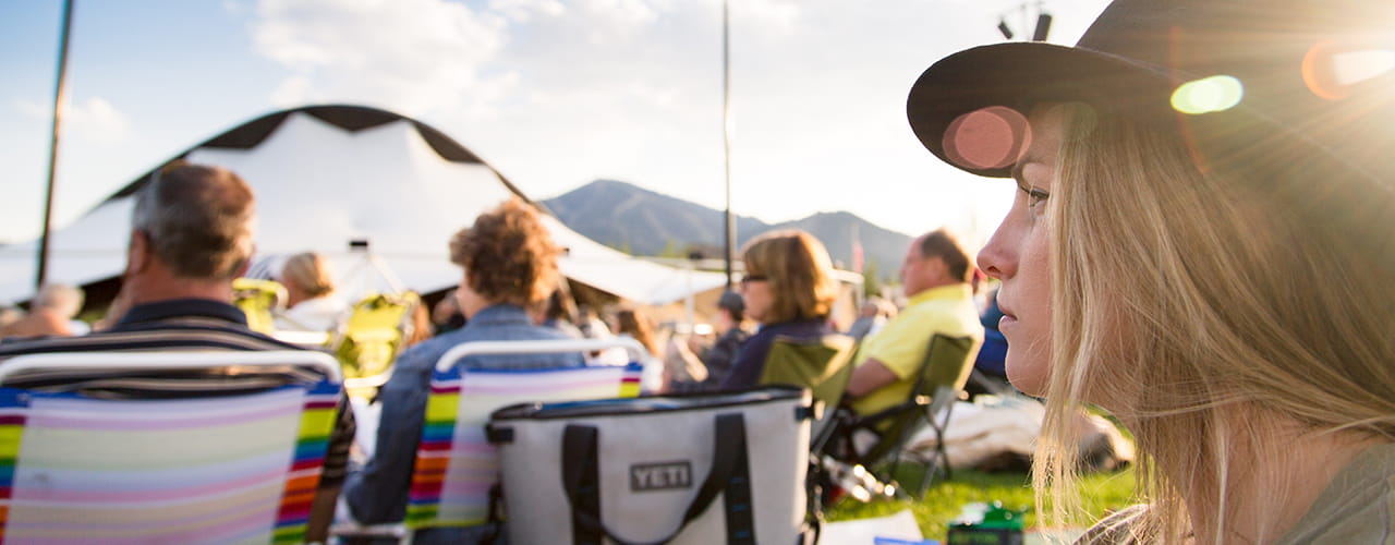 woman sitting at outdoor music festival