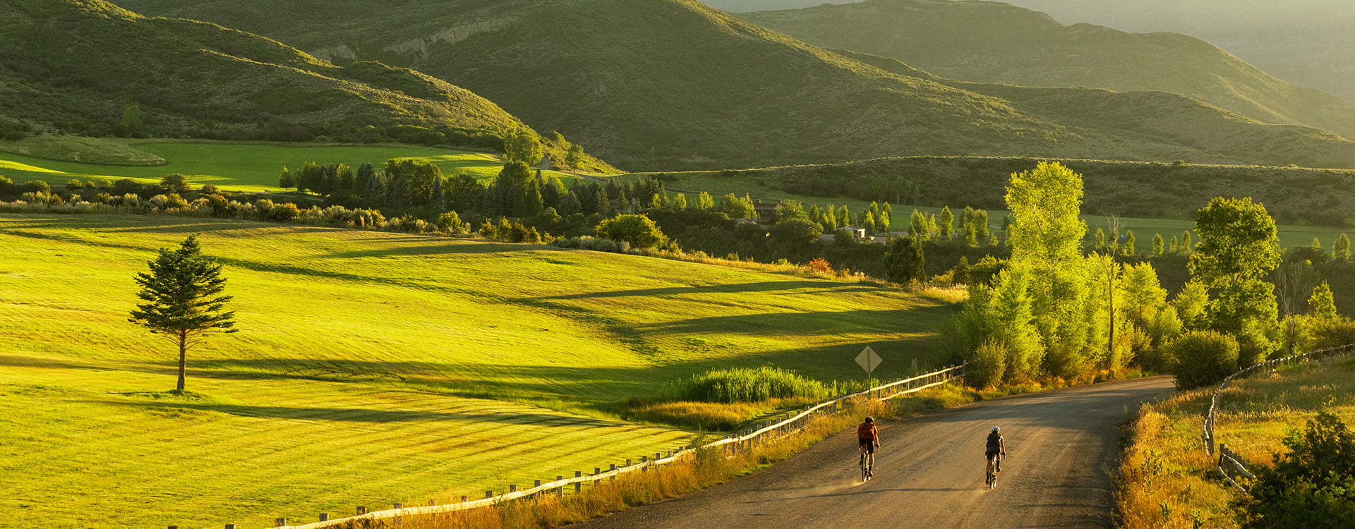 people riding bikes on dirt road