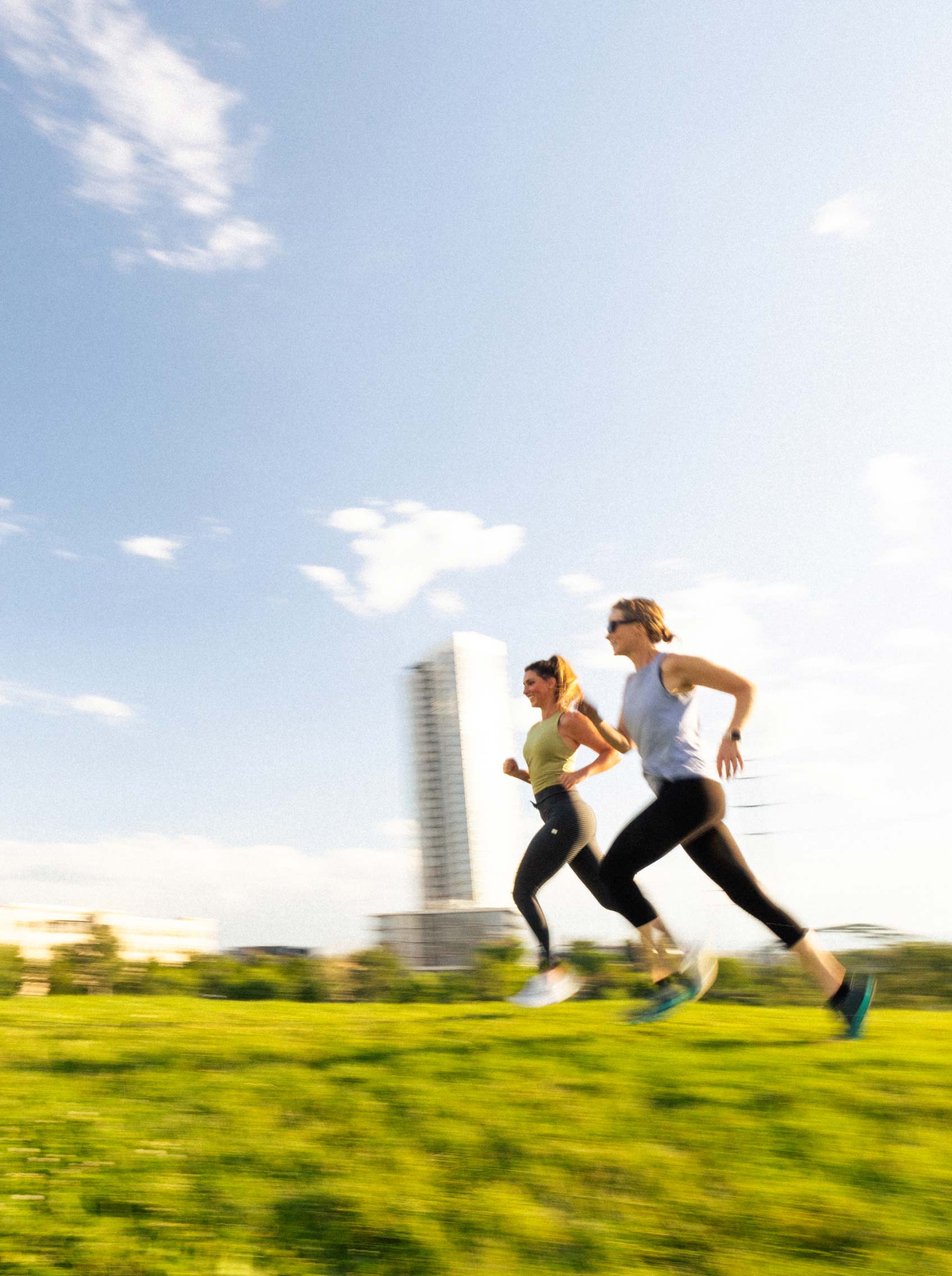 two runners running through park