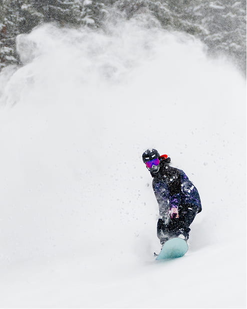 snowboarder skiing powder