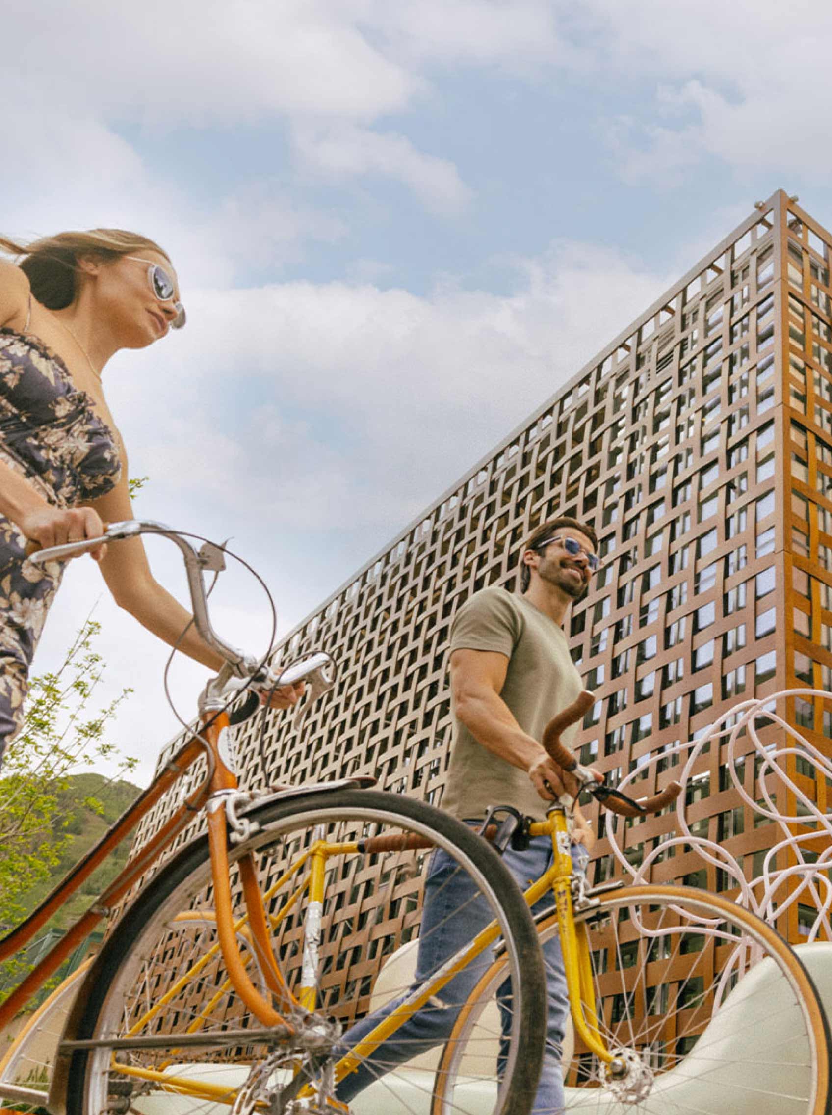 couple with bikes in front of aspen art museum