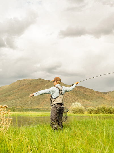 man fly fishing in the mountains