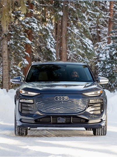 audi car driving in forest in winter