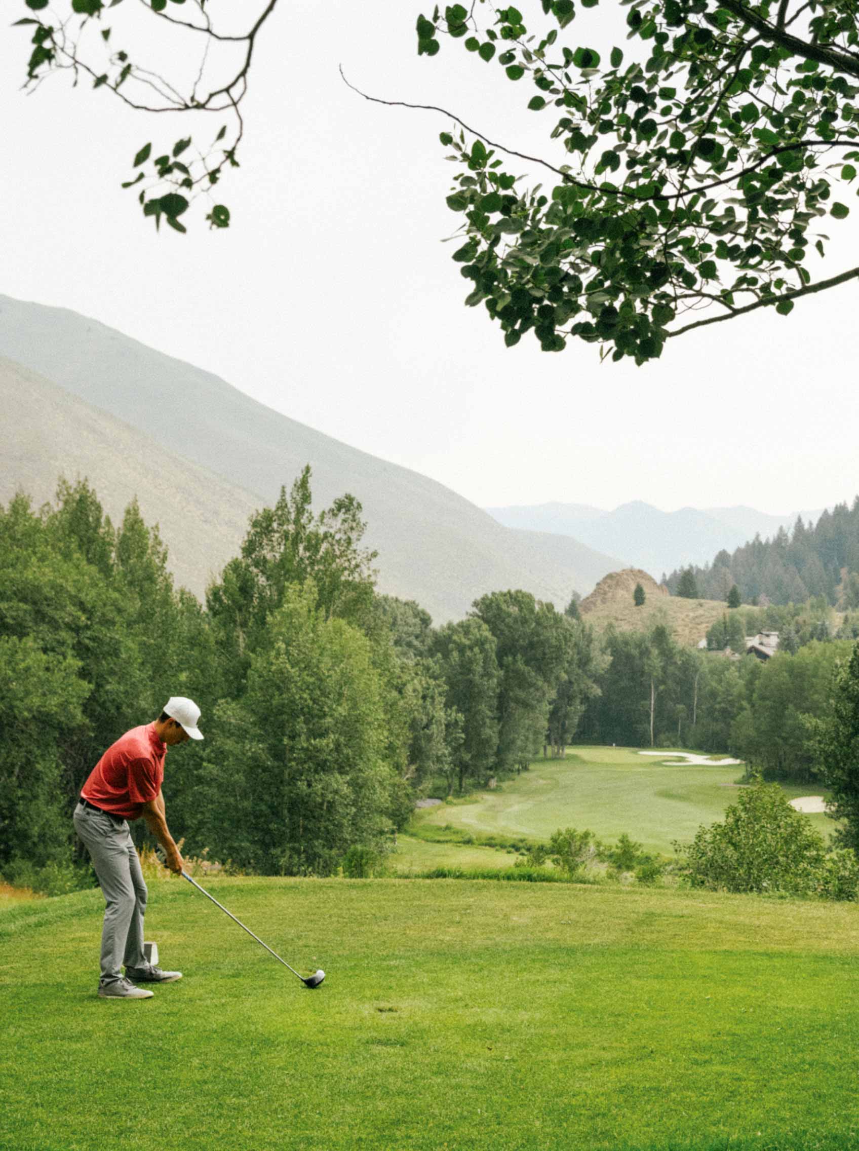 golfer golfing in mountains